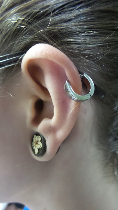 Our trademarked Snaplock Clicker shown here in a helix piercing