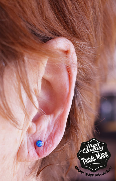 This 14g threaded titanium blue opal bead was the perfect choice for this clients ear lobe!